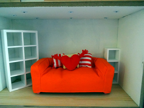 Couch, heart shaped pillow, and large white bookcase: part of the IKEA huset doll furniture set. Smaller white bookcase purchased from Manor House Miniatures. Other pillows were from IKEA's Lillabo collection.